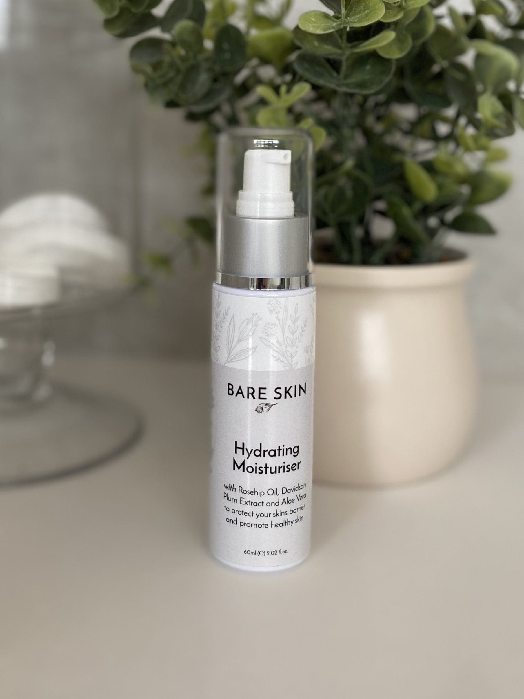 Bare Skin Hydrating Moisturiser barrier repair and deep hydration cream bottle on neutral surface with plant and cotton rounds, nourishing daily face cream.