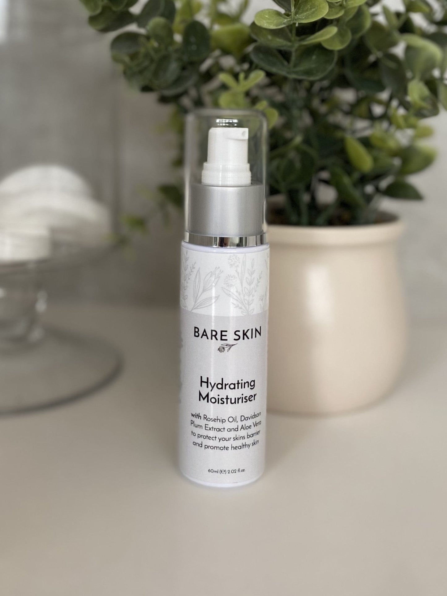 Bare Skin Hydrating Moisturiser barrier repair and deep hydration cream bottle on neutral surface with plant and cotton rounds, nourishing daily face cream.