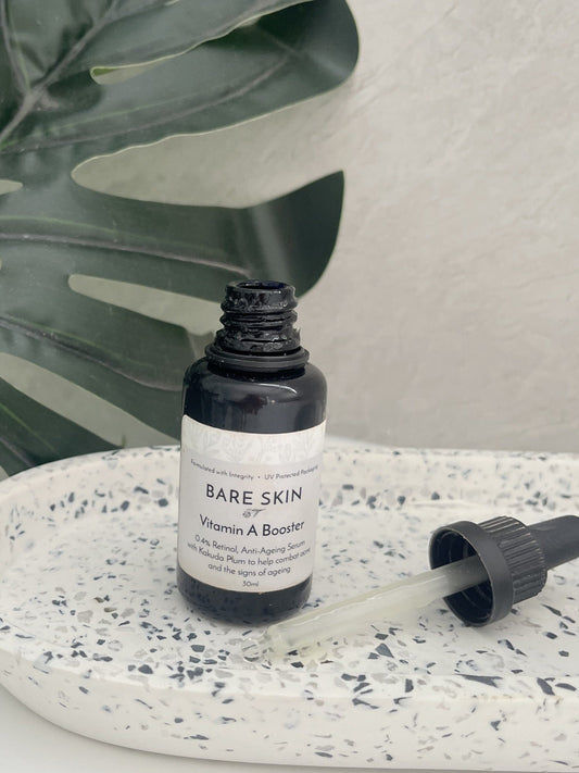 Bare Skin Vitamin A Booster encapsulated retinol serum for sensitive skin bottle on speckled ceramic tray with leaf background.