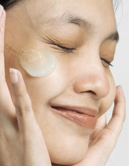 Woman applying Bare Skin Retinol Serum on her face.