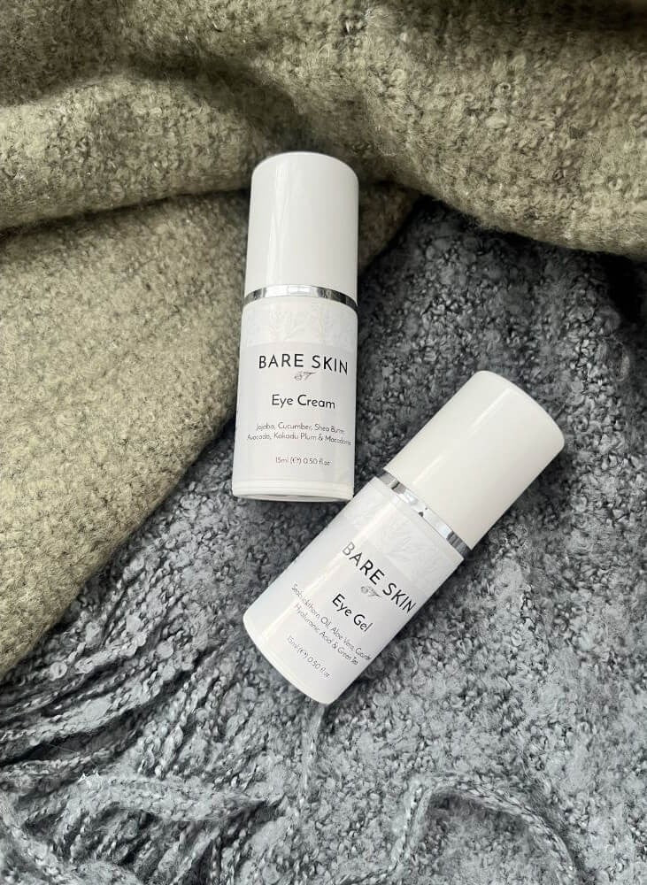 Bare Skin Cooling Eye Gel with Aloe Vera, Cucumber and Green Tea and Bare Skin Hydrating Eye Cream on textured green and grey blanket, hydrating soothing eye skincare duo.