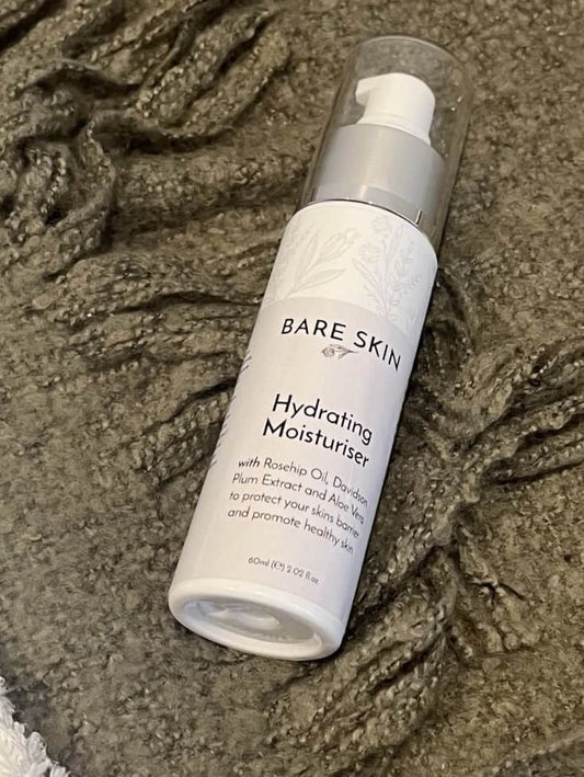 Bare Skin Hydrating Moisturiser barrier repair and deep hydration cream bottle on green blanket, nourishing cream for dry and sensitive skin.