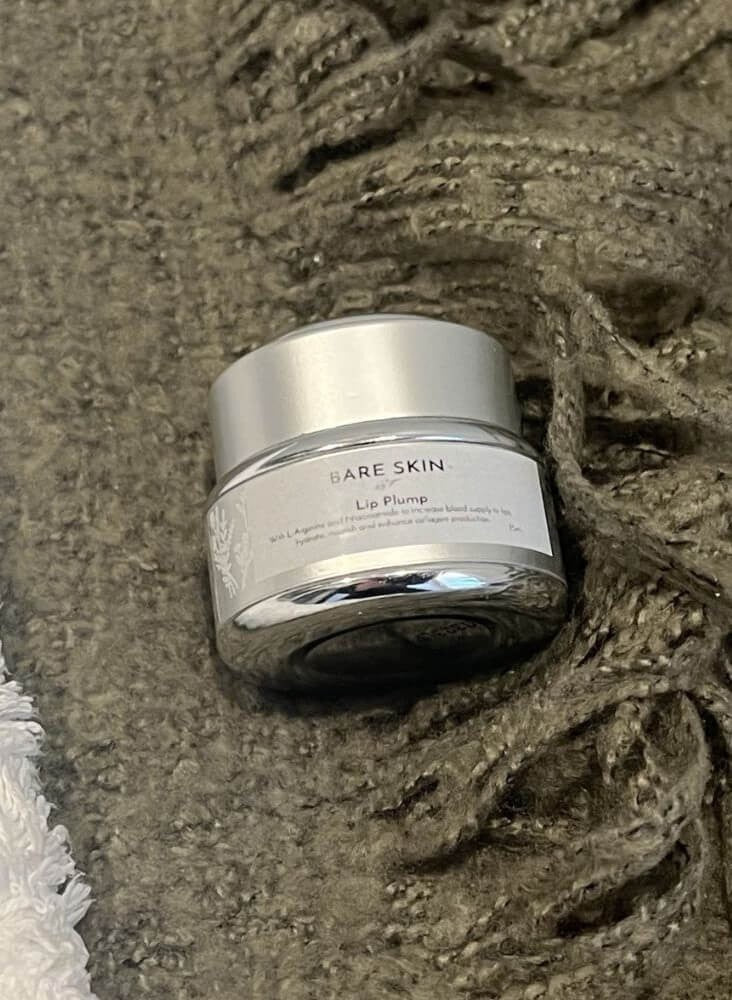 Bare Skin Lip Plump product laying on a green blanket
