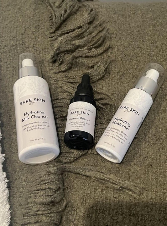Bare Skin Hydration Essentials Kit with Hydrating Milk Cleanser, Vitamin B Booster and Hydrating Moisturiser on green blanket, 3 step routine for barrier repair and lasting hydration.