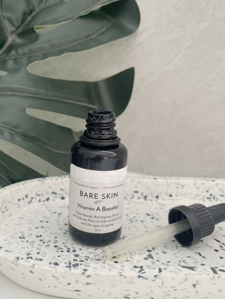 Bare Skin Vitamin A Booster encapsulated retinol serum for sensitive skin bottle on speckled ceramic tray with leaf background.