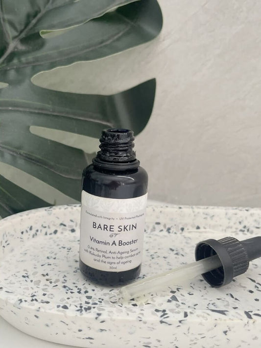 Bare Skin Vitamin A Booster encapsulated retinol serum for sensitive skin bottle on speckled ceramic tray with leaf background.